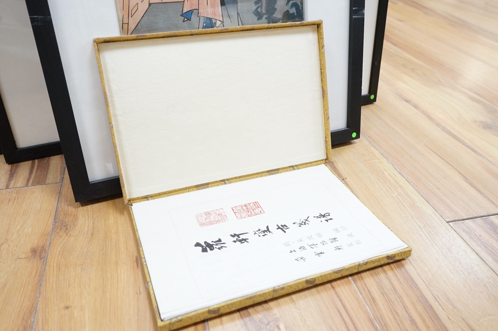 Four Japanese woodblock prints, to include: after Toyokuni - kabuki actors together with a Chinese printed booklet, largest 35 x 23cm. Condition - good